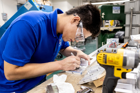 Neyton Baltodano Jr., a senior in the College of Engineering, is testing the strength of short carbon fibers.