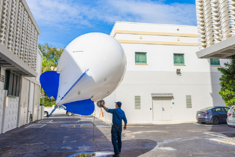 A smart balloon collects aerosol data at 200 feet of elevation over the McArthur Engineering Building.